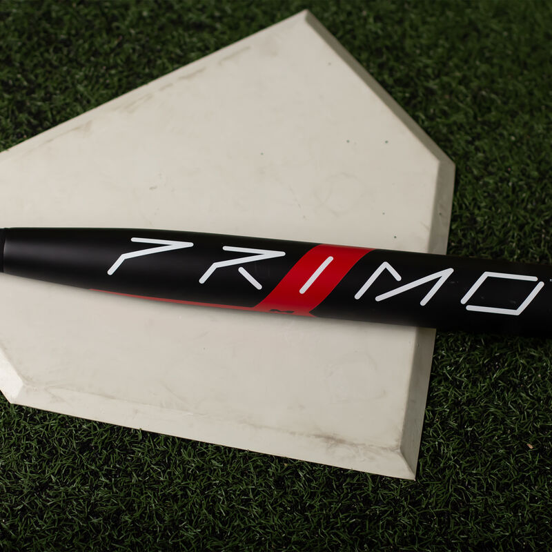 A black 2023 balanced Freak Primo USA bat on home plate in a batting cage - SKU: MSA3PRMB loading=