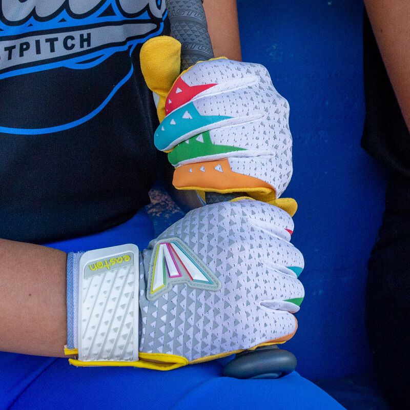 Picture of two hands wearing white Easton x Happiness Project Ghost NX fastpitch batting gloves holding a bat