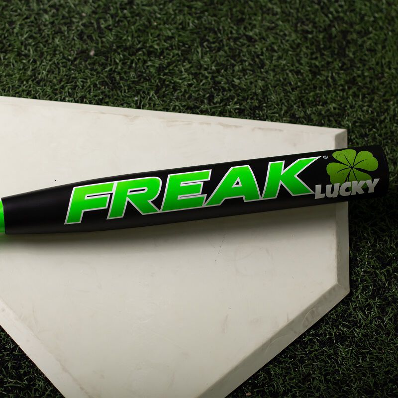 A black/green Freak Lucky USA bat on home plate - SKU: MSA3FLKL