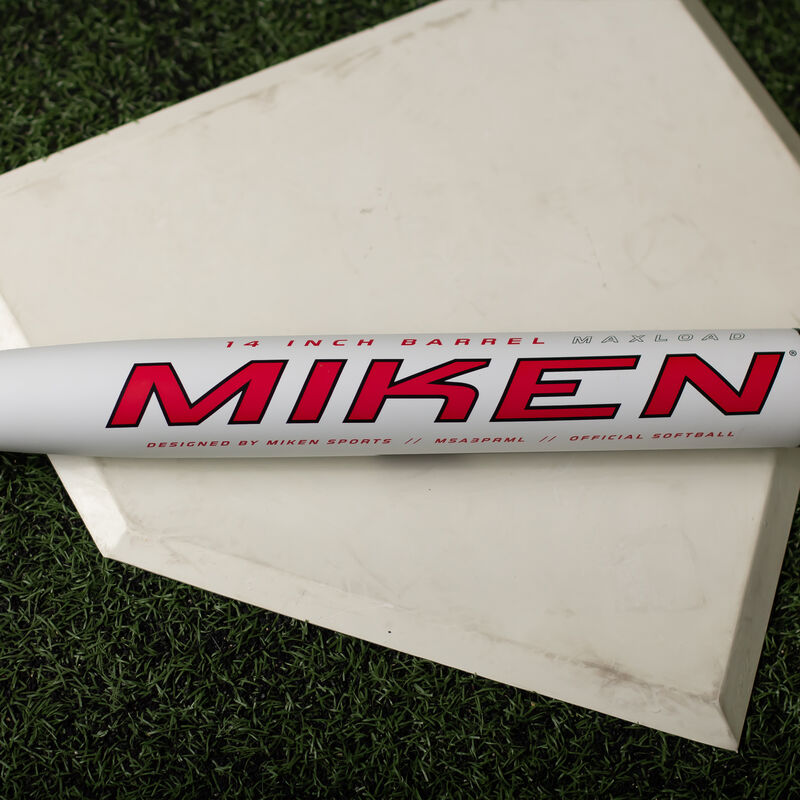 A white Miken Freak Primo USA bat on home plate in a batting cage - SKU: MSA3PRML